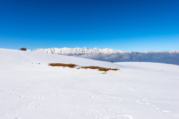 Mountain range of the Monte Baldo and Adamello in winter with snow, view from the Altopiano della Lessinia (Lessinia Plateau), Verona Province. Veneto and Trentino Alto Adige, Italy, Europe.