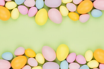 Fototapeta na wymiar Stylish background with colorful easter eggs pastel colors isolated on green background. Flat lay, top view, mockup, overhead, template