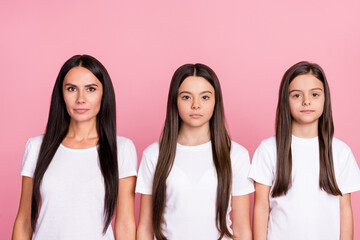 Photo portrait of calm serious mother and daughters wearing white t-shirts isolated pastel pink color background