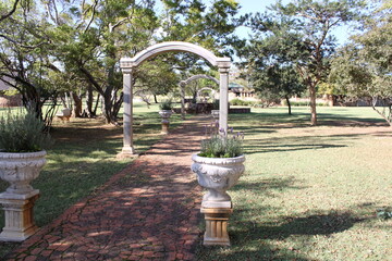 arch along a stone path with trees