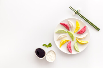 Homemade vegetables dumpling tortellini or ravioli on white plate, overhead view