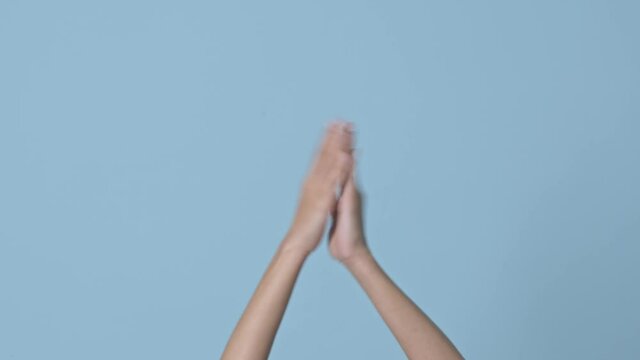 Woman hands arms applauding ongratulation gesture isolated on blue background in studio. Place for text image promotional content.