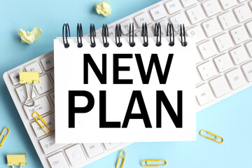 NEW Plan . Concept in business. text on white notepad paper on white keyboard