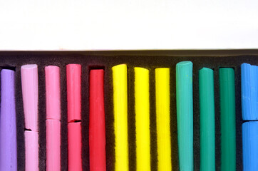 Rainbow bright colored pastel crayons in a box