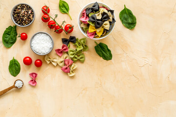Cooking background with Italian pasta and tomatoes with fresh basil