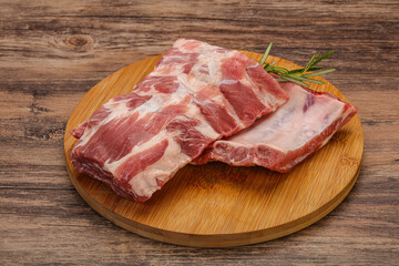 Raw pork ribs served rosemary