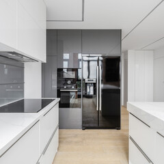 Black fridge in white kitchen
