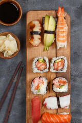 Sushi Set nigiri and sushi rolls on a wooden tray