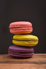 Colorful macaroons. Sweet macarons on retro dark background