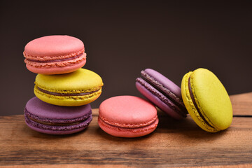 Colorful macaroons. Sweet macarons on retro dark background