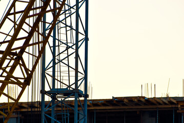 Silhouette of a crane on a background of sunset. Ropes and hooks on a white  background.