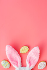 Happy Easter. Bunny ears with colorful eggs cookie, top view