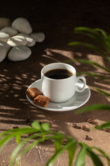 A cup of coffee on a stone background. Hard light. 