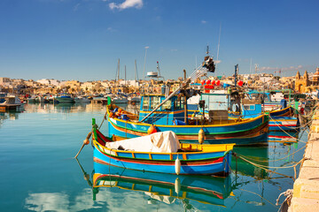 Obraz premium Traditional fishing boats in the Mediterranean Village of Marsaxlokk, Malta