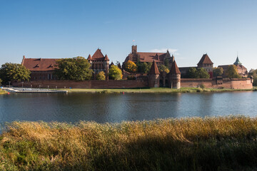 Fototapeta na wymiar View to Malbork Castle in Poland and its reflection in river Nogat