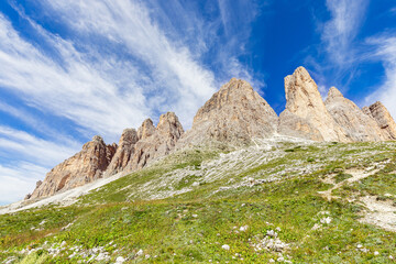 Fototapeta na wymiar Peaks of the Dolomites against the backdrop of a beautiful blue sky. South Tyrol, Italy