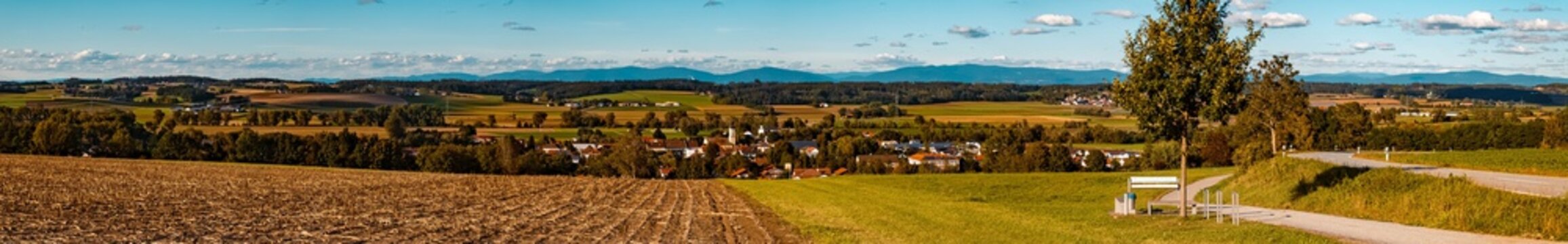 High resolution stitched panorama of a beautiful autumn or indian summer view with the Bavarian forest in the background near Eichendorf, Bavaria, Germany