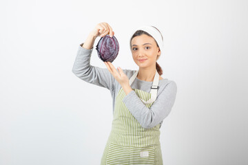 Picture of positive woman posing with purple cabbage on white background