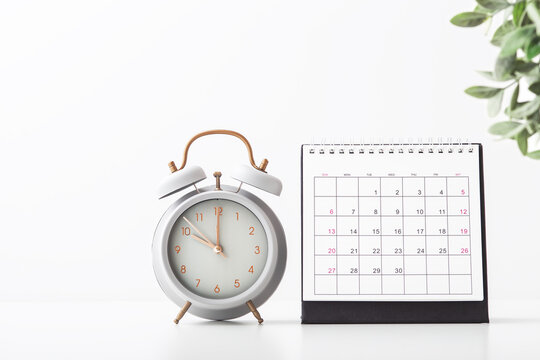 Alarm Clock And Calendar On White Background