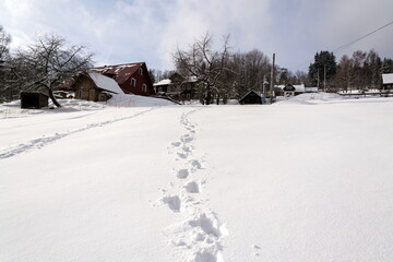 Shoe footprint in fresh snow on empty ski slope, winter snowy landscape on sunny day, white copy space, new year resolution sport concept