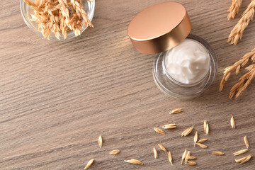 Natural moisturizing cream with oat extract with spikes top view