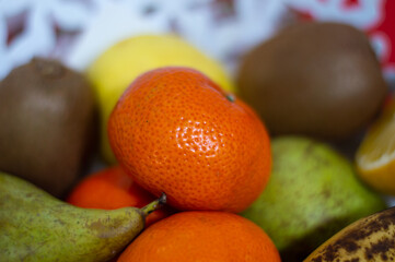 Still life of seasonal fruit with oranges, tangerines, bananas, pears and kiwis. Fruit of the Mediterranean coast.