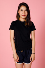 Obraz premium Active and sporty character young and cute Asian girl in t-shirt and shorts posing to the camera with self-confidence.