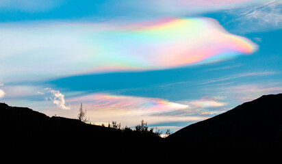Multicolored rainbow cloud in natural sky background. Unusual and beautiful meteorological...