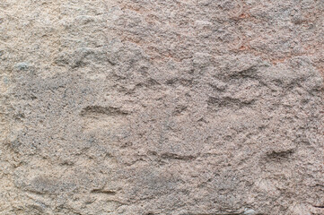 Natural pinky grey stone background texture.  Natural lighting, textured surface for use as a textured layer or overlay.