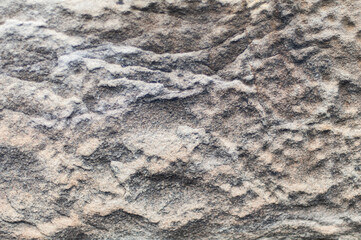 Natural rough stone texture, pale grey with a hint of pink and orange.  Textured with shadows, shot...