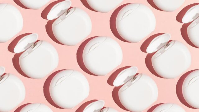 Stop motion animation pattern Closed white boxes with dental floss alternate between open boxes on a pink background