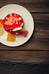 Round red cake on a plate marmalade sweets dessert