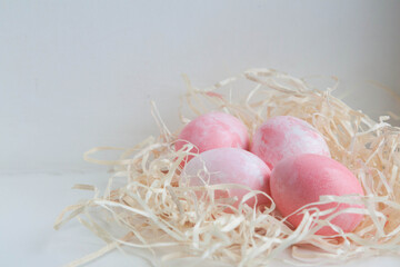 easter eggs in a nest. pink eggs. Easter. eggs on white background.

