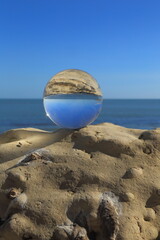 Clear glass ball sphere on the rock