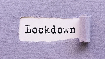 The text LOCKDOWN appears on torn lilac paper against a white background.