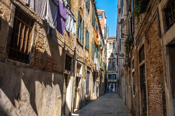 Old historic buildings along a narrow street. Venice, Italy