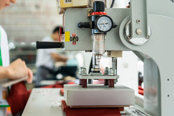 Detail of employee working in Chinese clothing factory