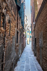 Fototapeta na wymiar Old historic buildings along a narrow street. Venice, Italy