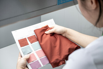Detail of employee working in Chinese clothing factory