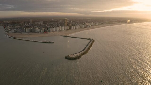 Aerial view of the little town of Ostend in northern region of Belgium facing the North Sea during a dramatic evening at sunset.