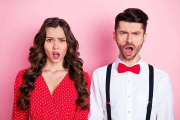 Portrait of nice stressed brown hair couple she wear dress he shirt isolated on pastel pink color background