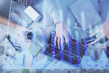 Double exposure of man and woman working together and forex graph hologram drawing. Financial analysis concept. Computer background. Top View.
