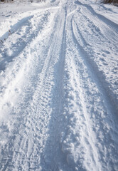 Fototapeta na wymiar Snowy winter road in the forest