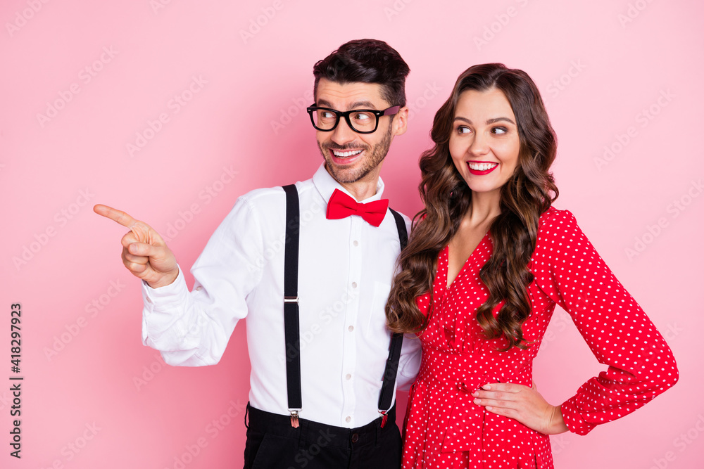 Wall mural Photo of nice optimistic brown hair couple look empty space wear trend cloth isolated on pastel pink color background