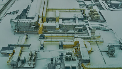Snow-covered outdoor industry system of ventilation. The external units of the commercial air conditioning and ventilation systems are installed on the street.