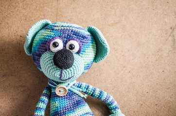 Knitted blue striped handmade crafted cat. Children's toy.