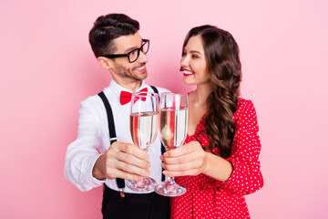 Photo of nice optimistic brown hair couple hold glasses celebrate wear trend cloth isolated on pink color background