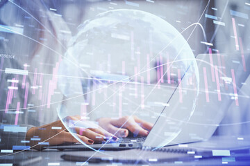 Double exposure of woman hands working on computer and forex graph hologram drawing. Financial analysis concept.
