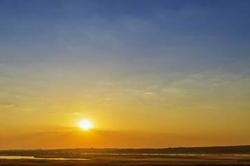 Stunning sunset with orange and blue clouds in dramatic sky