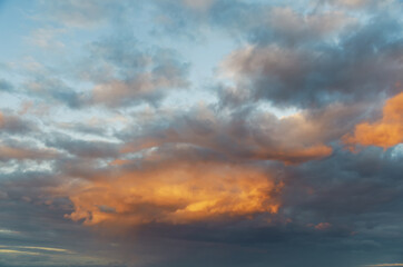 Stunning sunset with orange and blue clouds in dramatic sky